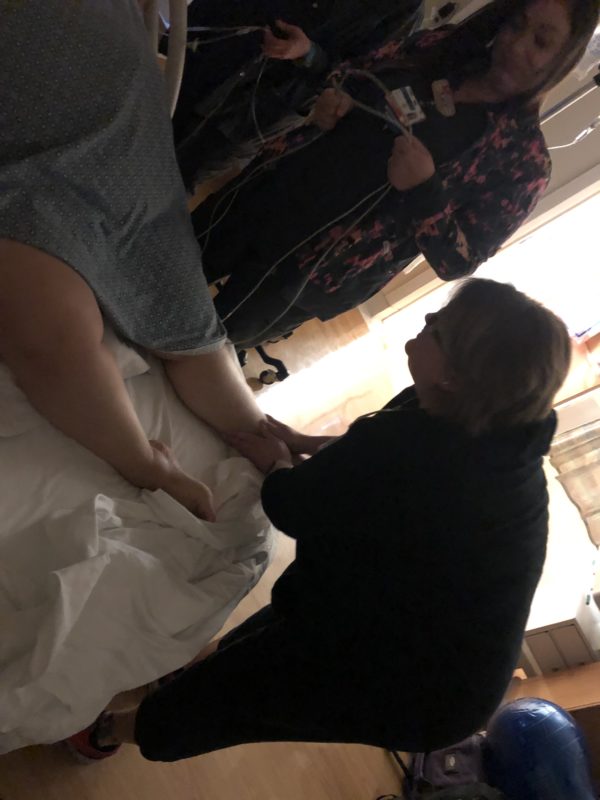 Rae massaging Mel’s feet